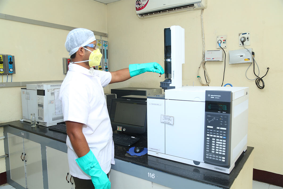 Lab assistant measuring chemicals for an experiment.