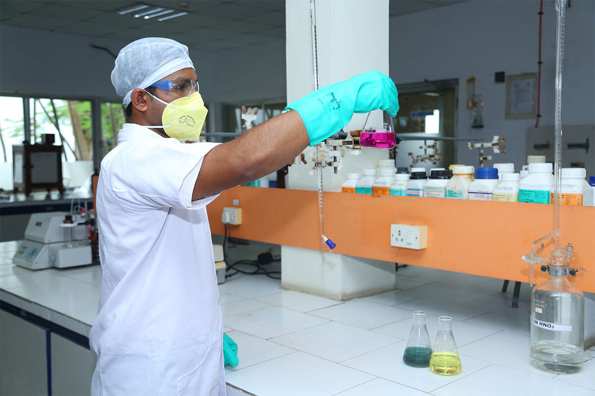 Scientist mixing solutions in a test tube rack